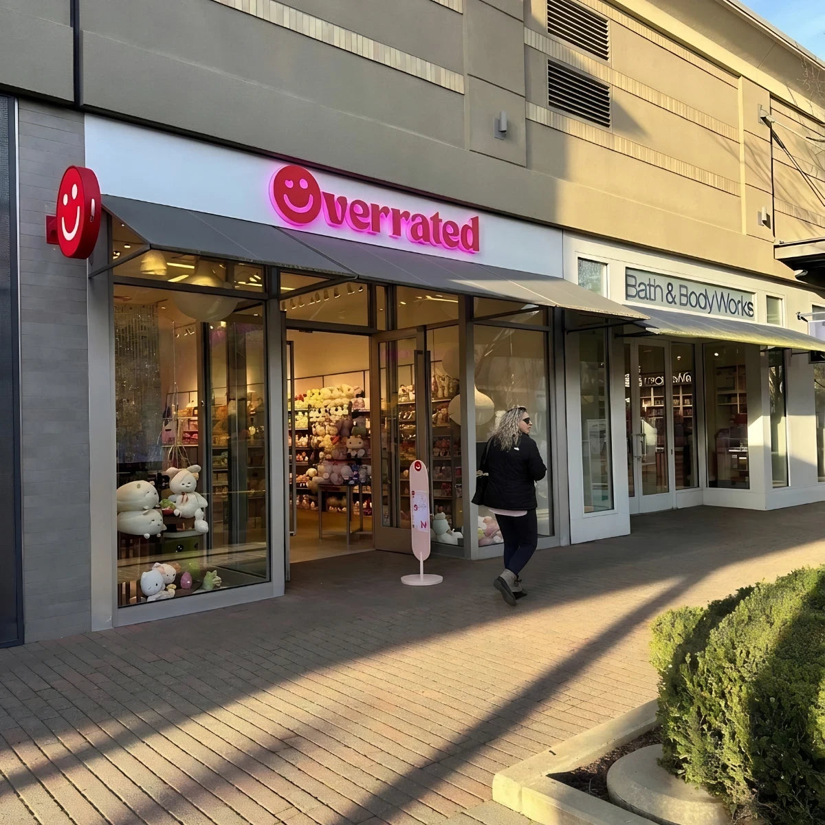 
Overrated Korean Beauty and More retail store exterior at Westland Mall featuring neon pink signage and kawaii plush display in window