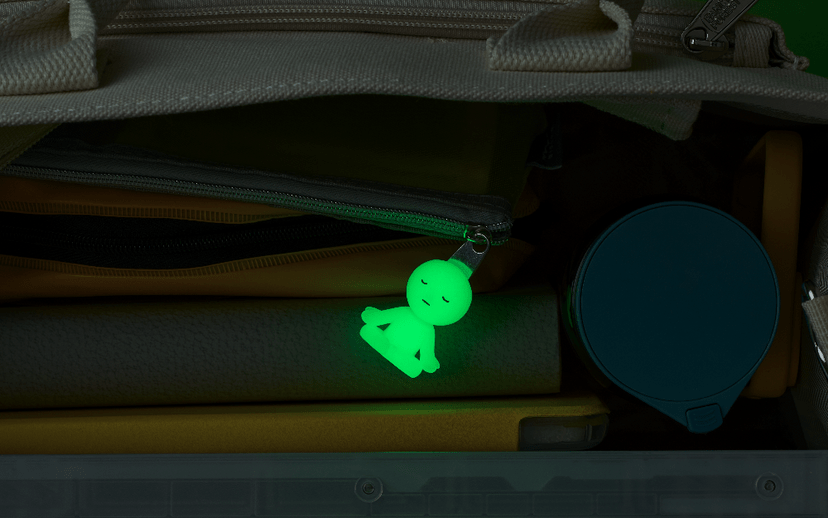 Smiski glow in the dark figure ZipperBite attached to zipper closeup - Overrated Korean Beauty & More